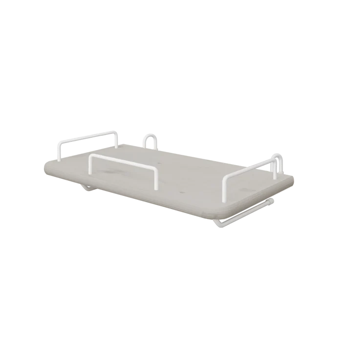 FLEXA bedside tray from the GREY collection, grey MDF with four white metal handles, child-safe edges, by a bed.