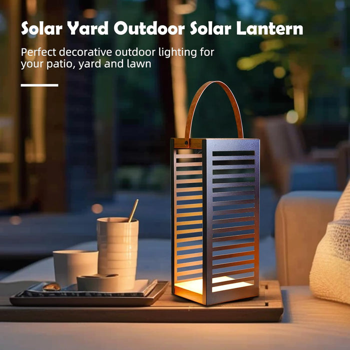 Solar yard outdoor lantern on a table with decorative items, set against a blurred patio background.