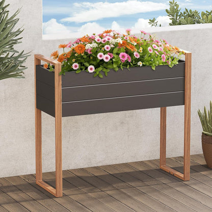 Gray planter box with wooden frame filled with flowers on a wooden deck.