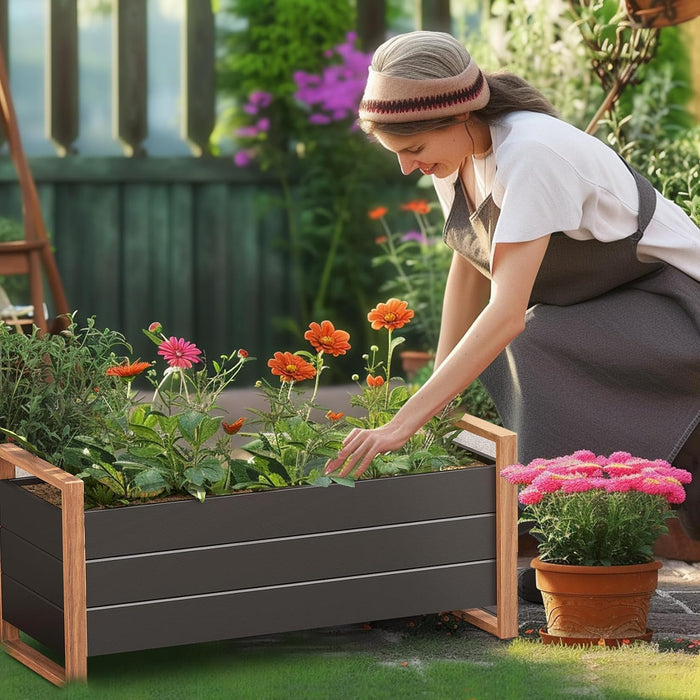 Woman tending to flowers in a raised garden bed in a garden setting