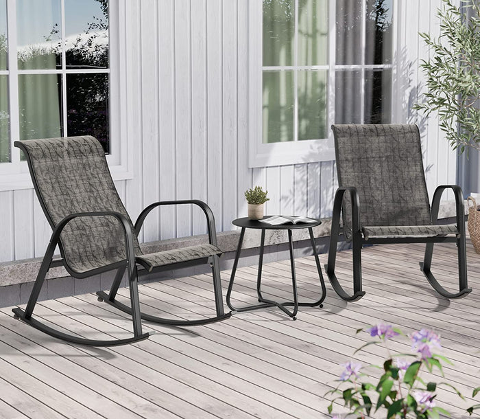 Two gray rocking chairs with a small table on a wooden deck.