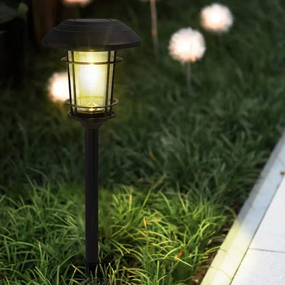 Solar garden light on grass with warm glow