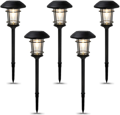 Set of five black outdoor solar path lights on a white background