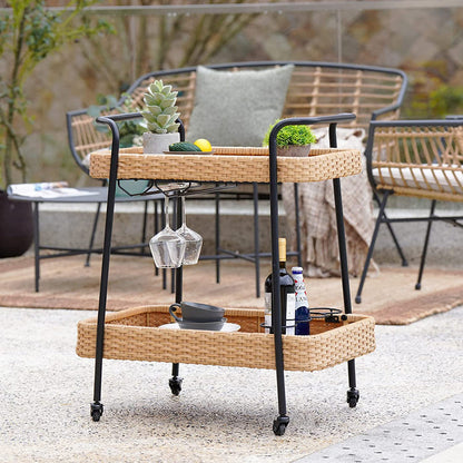 Wicker bar cart with drinks and glasses on a patio
