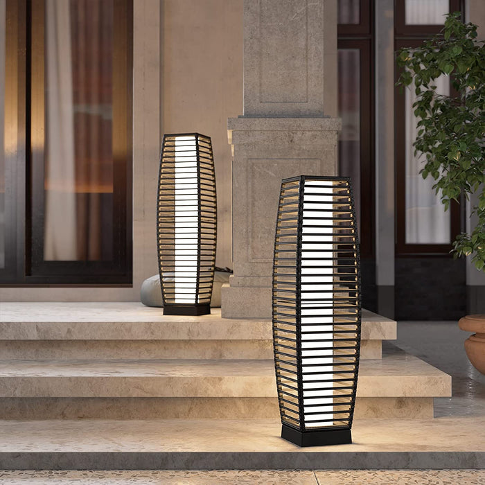 Grand Patio outdoor solar-powered crossover woven resin wicker floor lamp, featuring a tall, slender design with a warm glow.