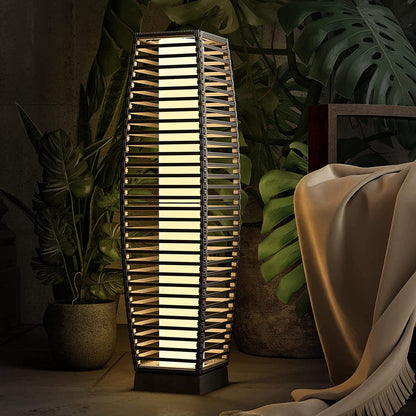 Grand Patio outdoor solar-powered crossover woven resin wicker floor lamp with a tall, elongated design and warm light.