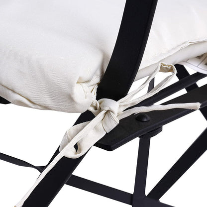 Close-up of a chair with white cushioned seat and black metal frame on a white background